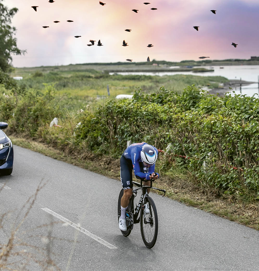 A man riding a bicycle on a road. Description generated by AI